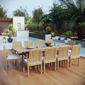 Outdoor dining set with wooden table and chairs on a wooden deck by a pool.