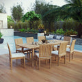 Outdoor dining set with wooden table and chairs by a poolside