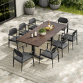 Outdoor dining set with a large table and chairs on a patio.