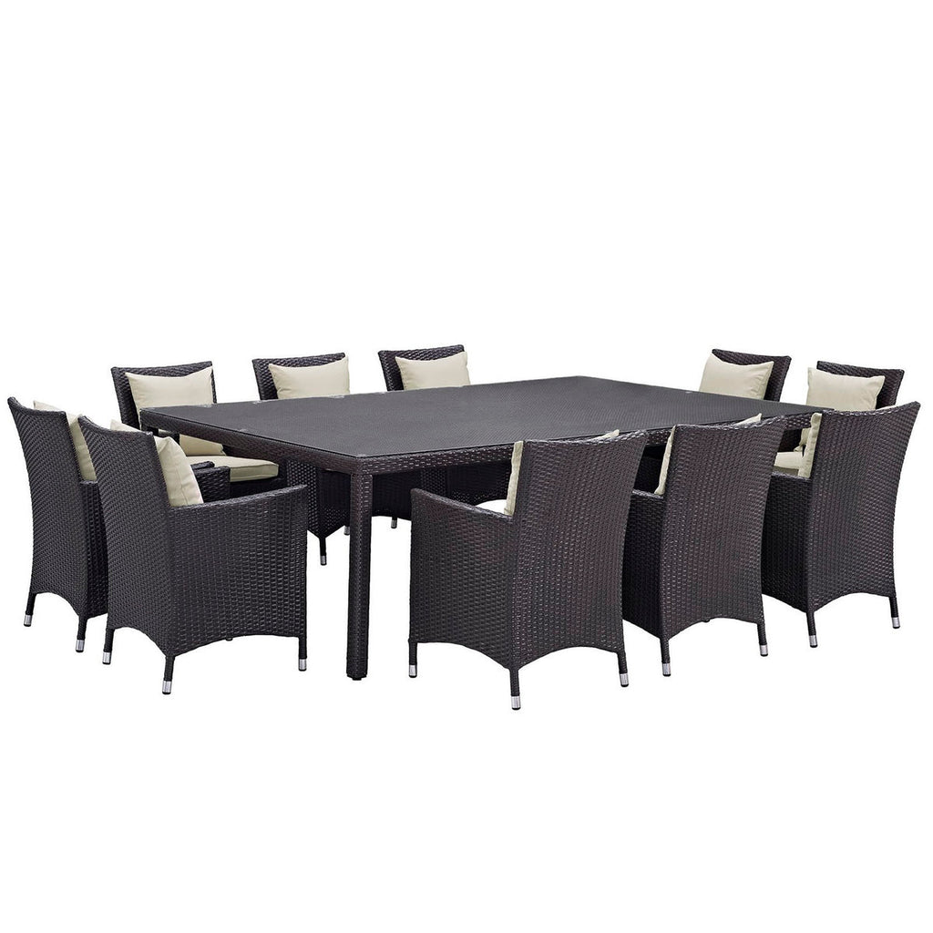 Outdoor dining set with a rectangular table and wicker chairs on a white background