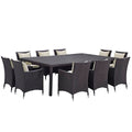 Outdoor dining set with a rectangular table and wicker chairs on a white background