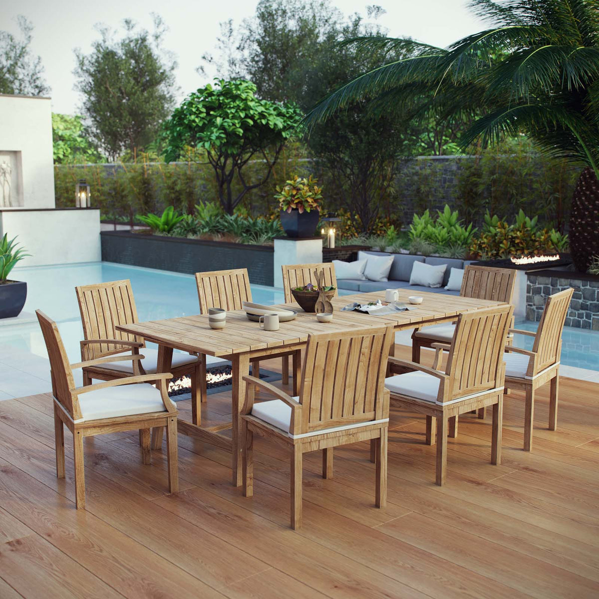 Outdoor dining set with wooden table and chairs on a wooden deck by a pool.