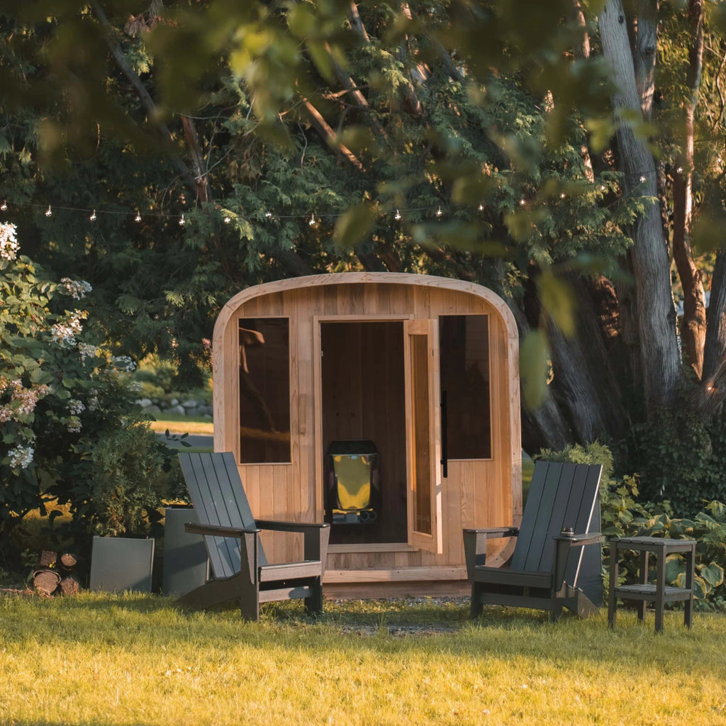 Wooden outdoor cabin with chairs in a garden setting