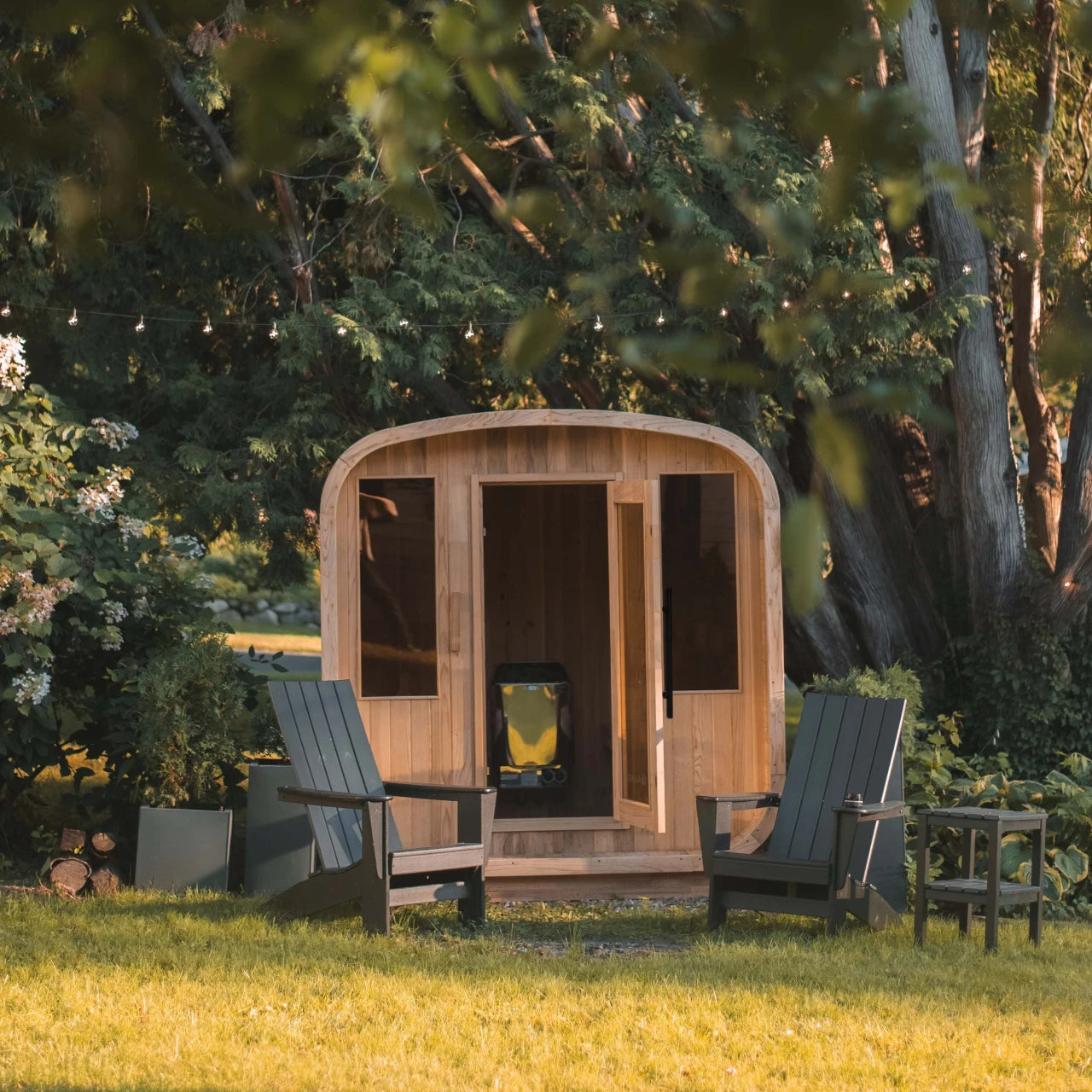 Wooden outdoor cabin with chairs in a garden setting