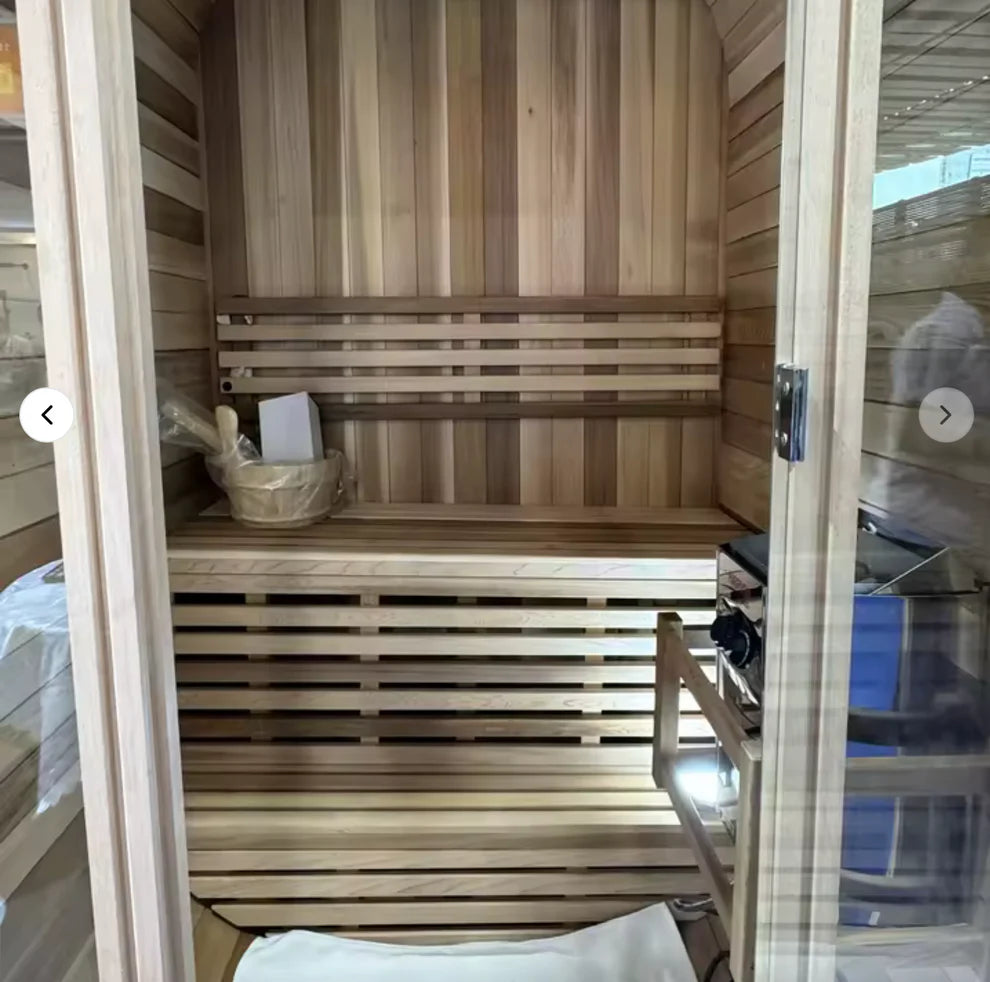 Wooden sauna with benches and a basket inside