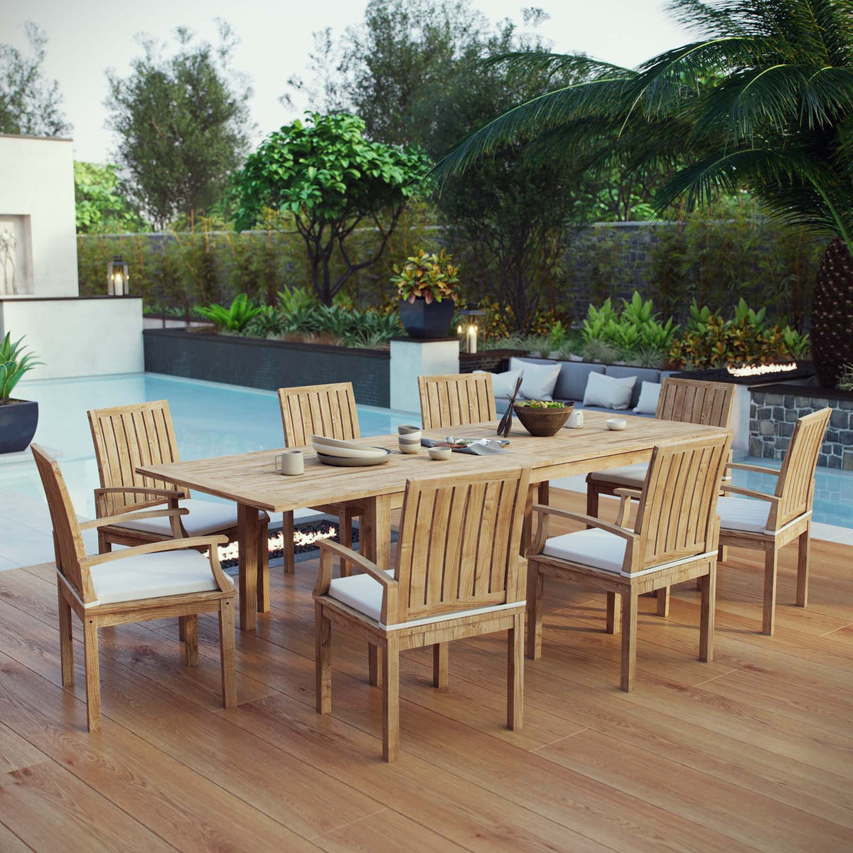 Outdoor dining set with wooden table and chairs on a wooden deck by a pool.