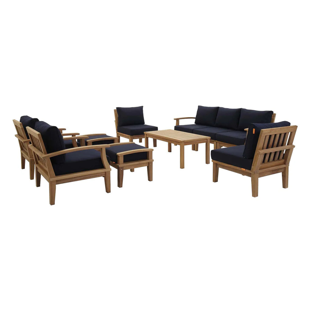 Outdoor furniture set with wooden frames and navy cushions on a white background