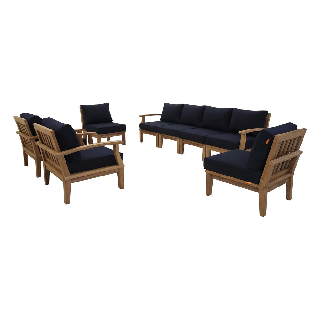 Outdoor furniture set with wooden chairs and sofa with navy cushions on a white background
