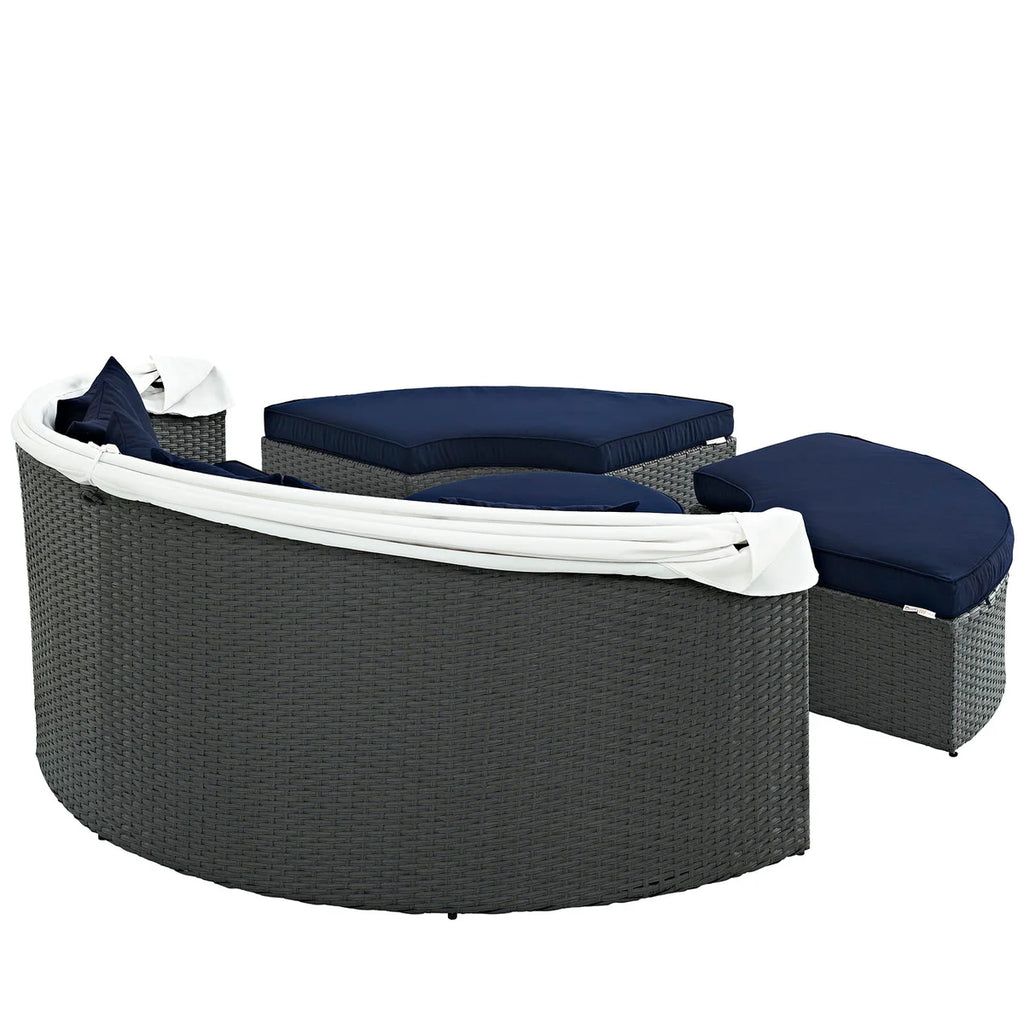 Outdoor furniture set with gray wicker frame and navy cushions on a white background