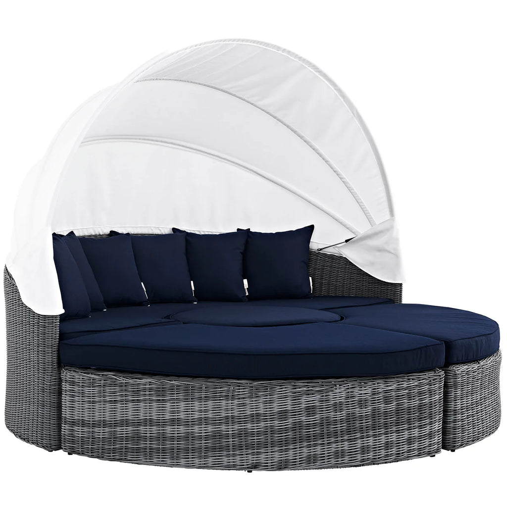 Outdoor lounge chair with canopy and navy cushions on a white background