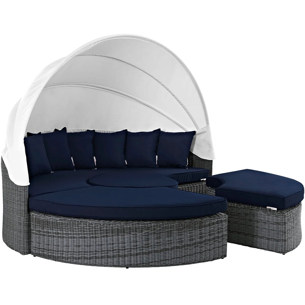 Outdoor lounge chair with canopy and navy cushions on a white background