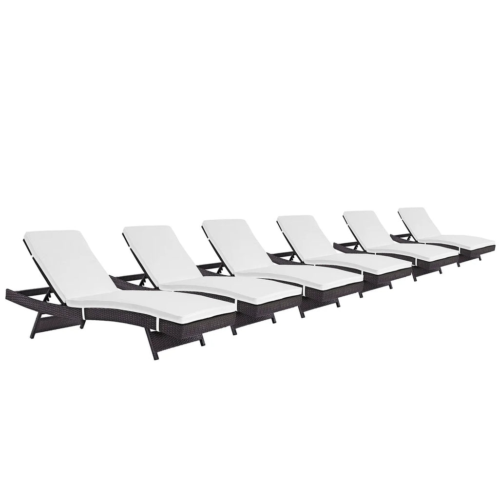 Set of six white lounge chairs with black frames on a white background