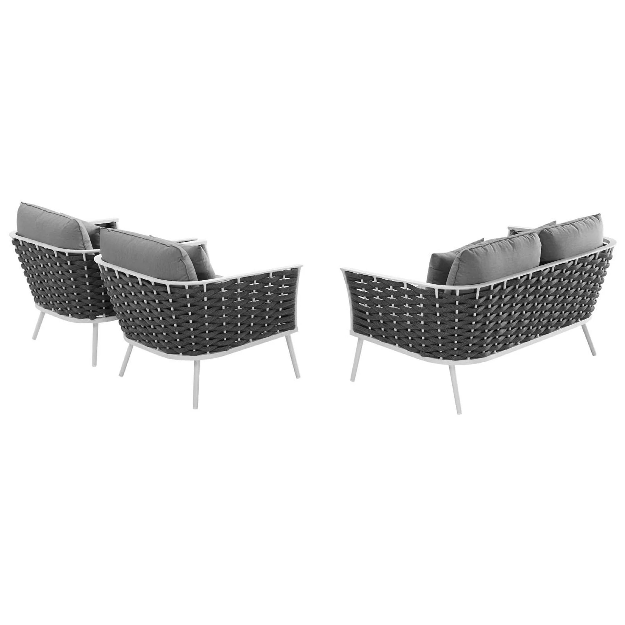 Outdoor furniture set with wicker chairs and cushions on a white background