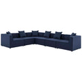 Navy blue sectional sofa with multiple cushions on a white background