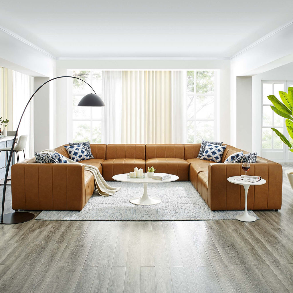 brown sectional sofa with throw pillows, side tables lamp, and bright white ceiling 