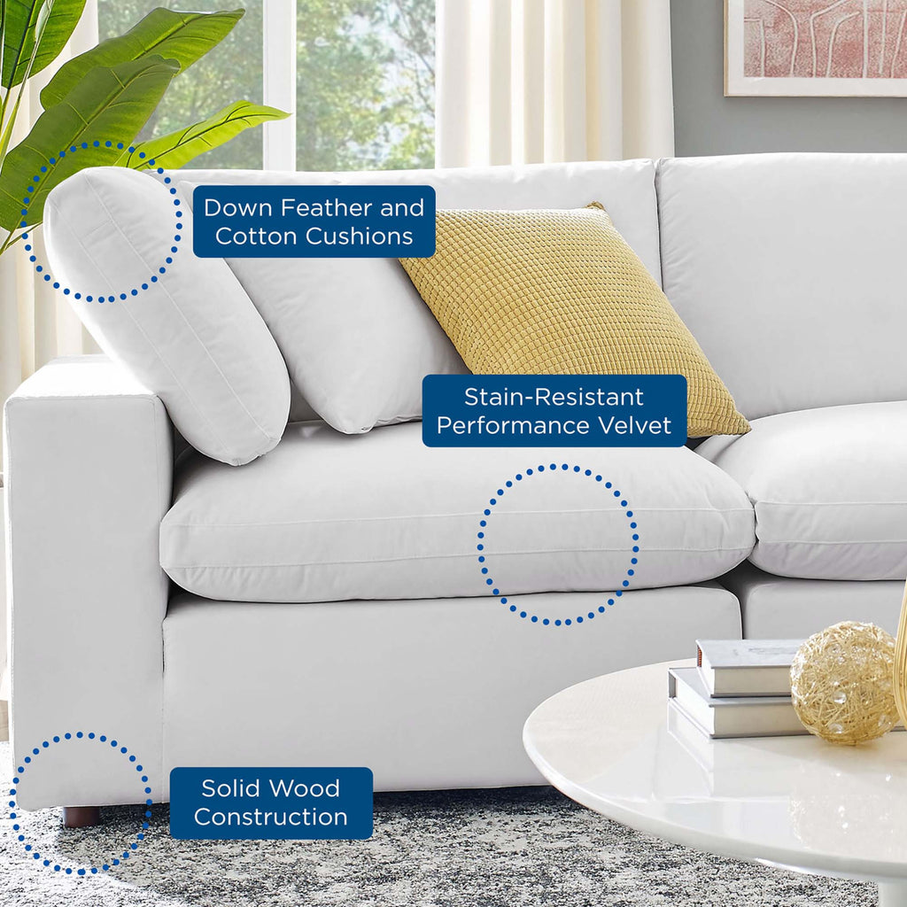 White sofa with yellow pillow in a living room setting, highlighting features like down feather and cotton cushions, stain-resistant performance velvet, and solid wood construction.