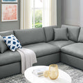 Gray sectional sofa in a living room with a coffee table and decorative items.