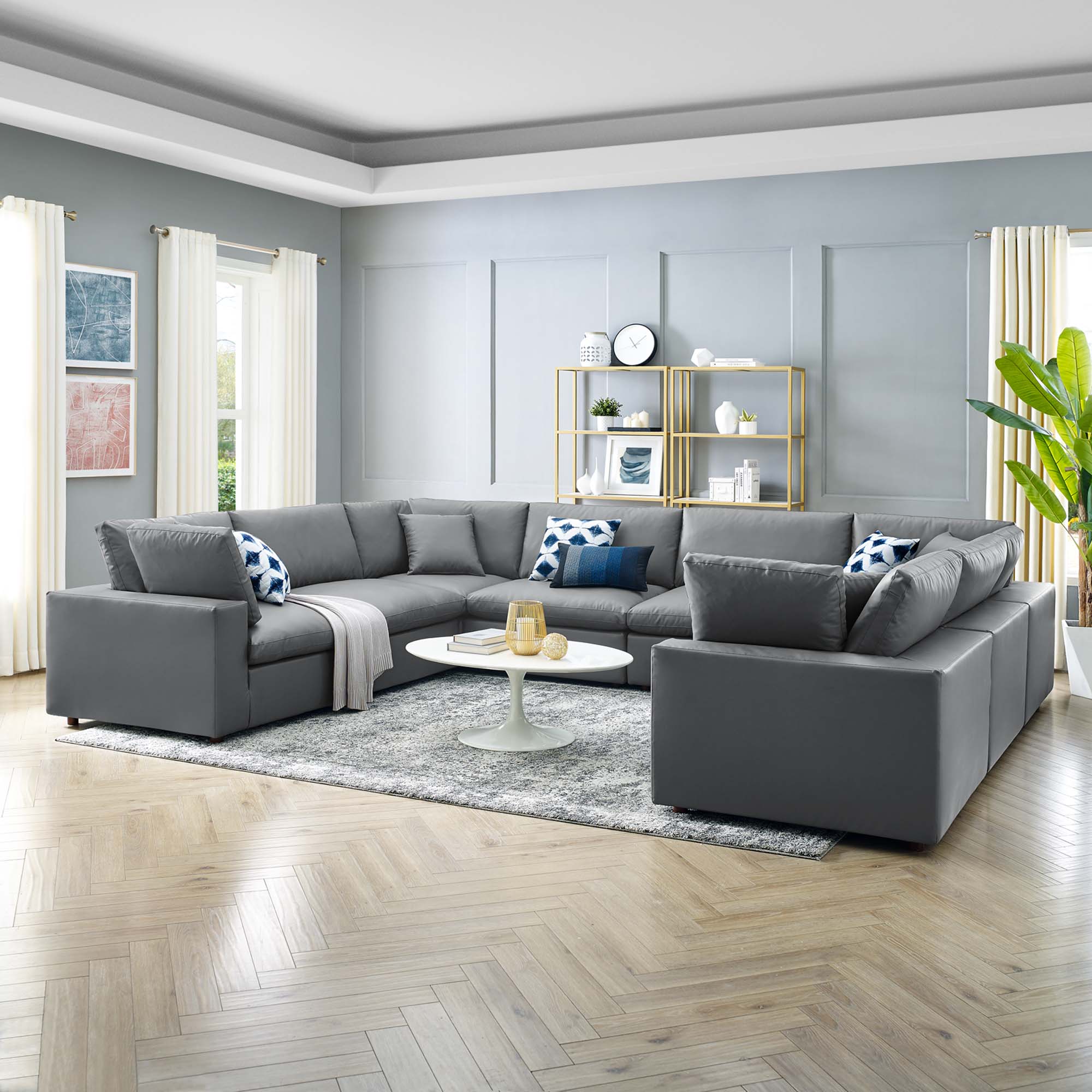 Modern living room with a gray sectional sofa, coffee table, and decorative items.