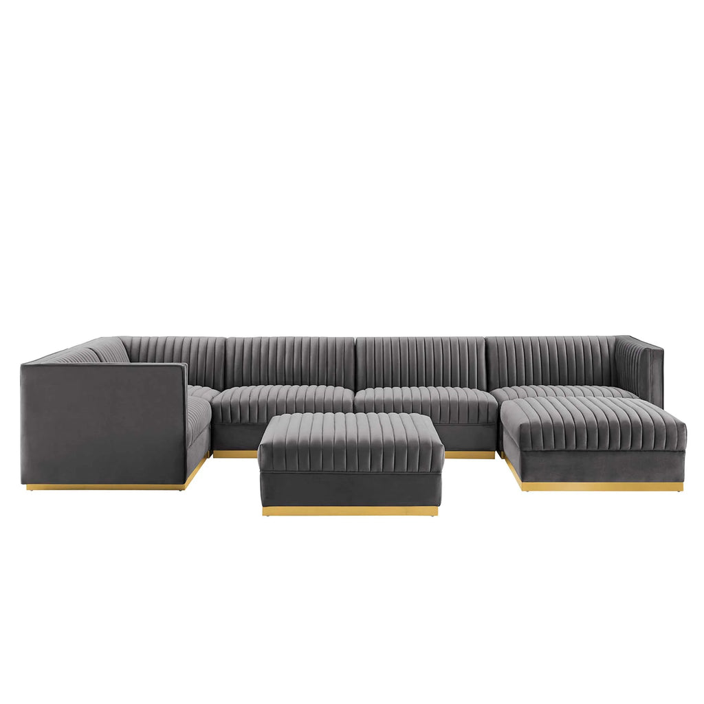 Gray sectional sofa with ottoman on a white background