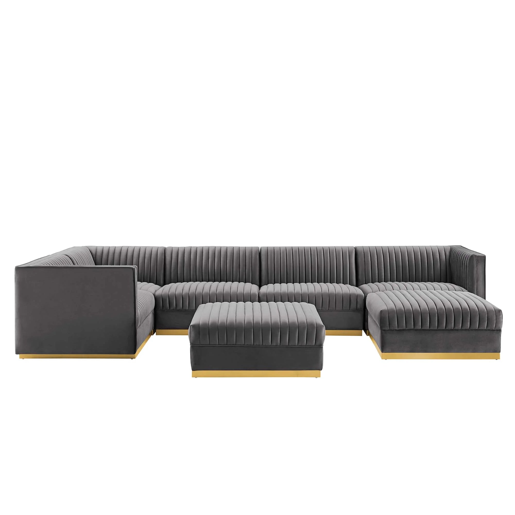 Gray sectional sofa with ottoman on a white background