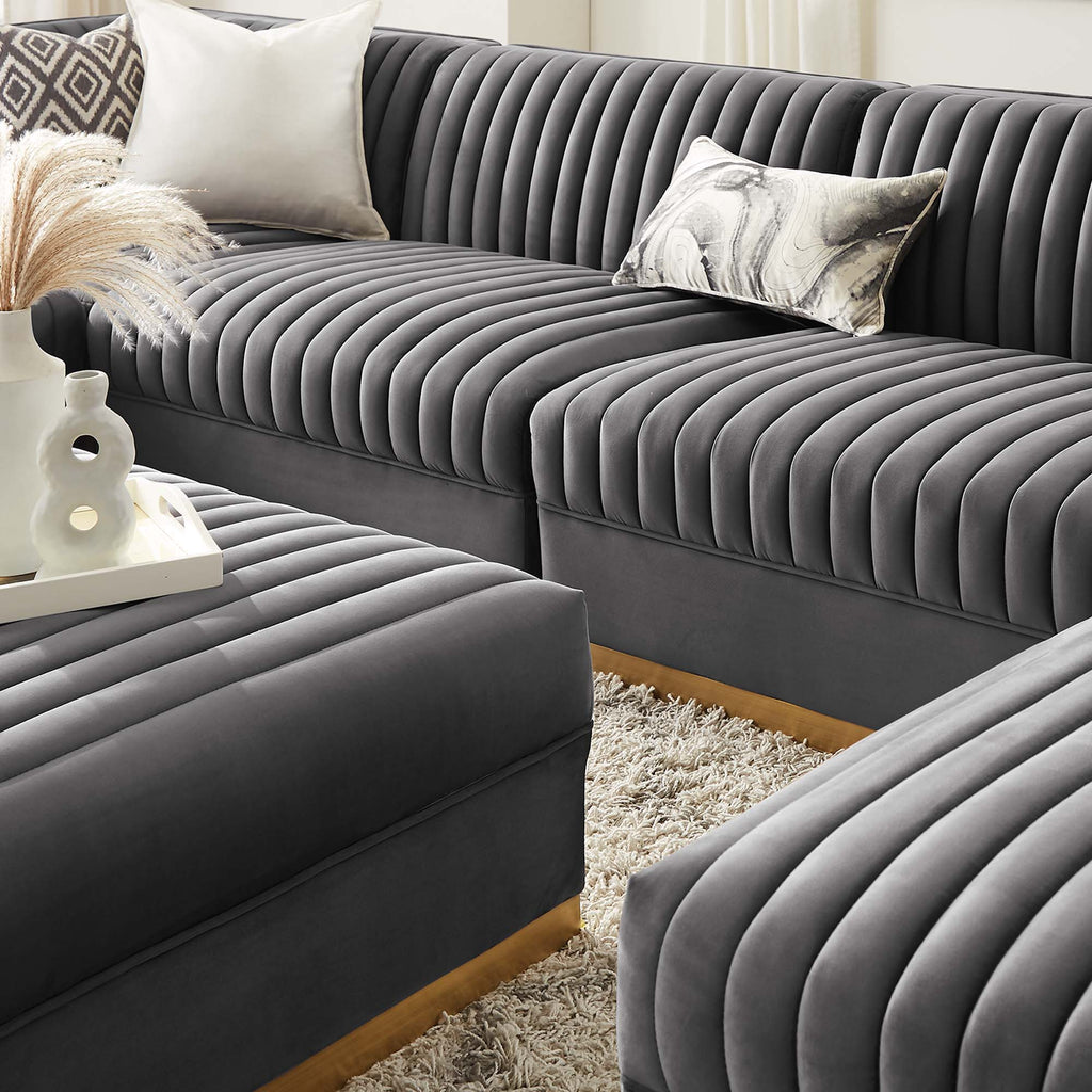 Gray sectional sofa with decorative pillows in a living room setting.