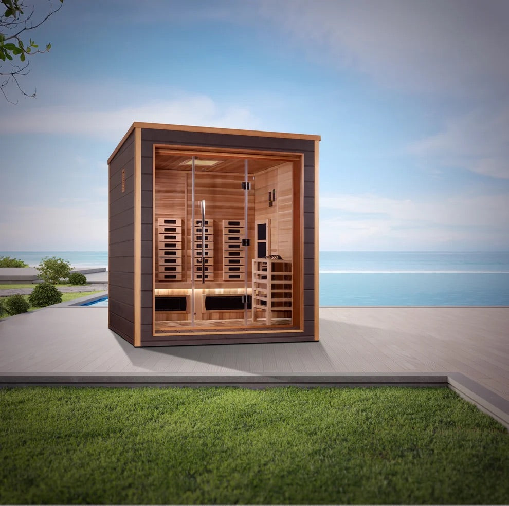 Wooden sauna cabin on a patio with a scenic background