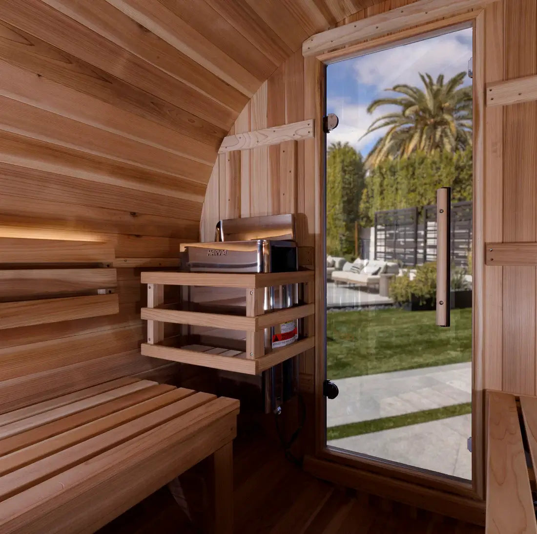 Wooden sauna interior with a view of a garden outside