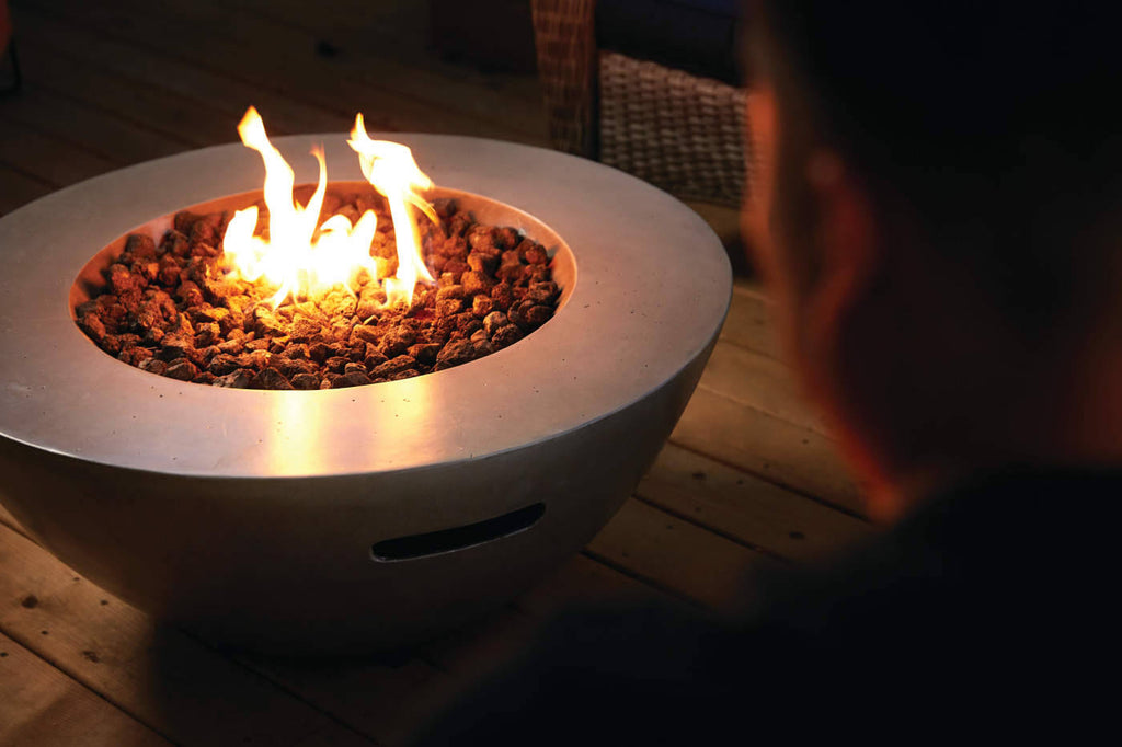 Fire pit with flames on a wooden deck