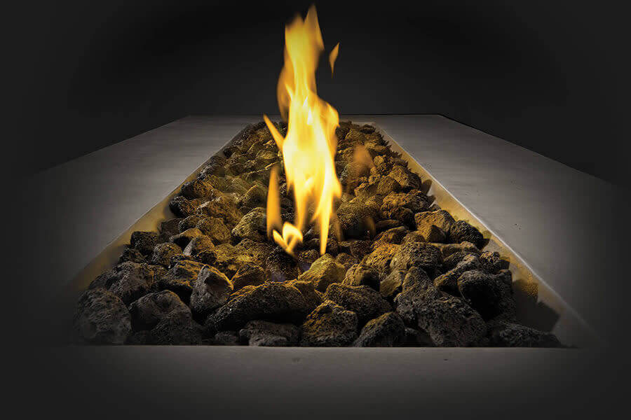 Fireplace with burning logs and flames on a dark background