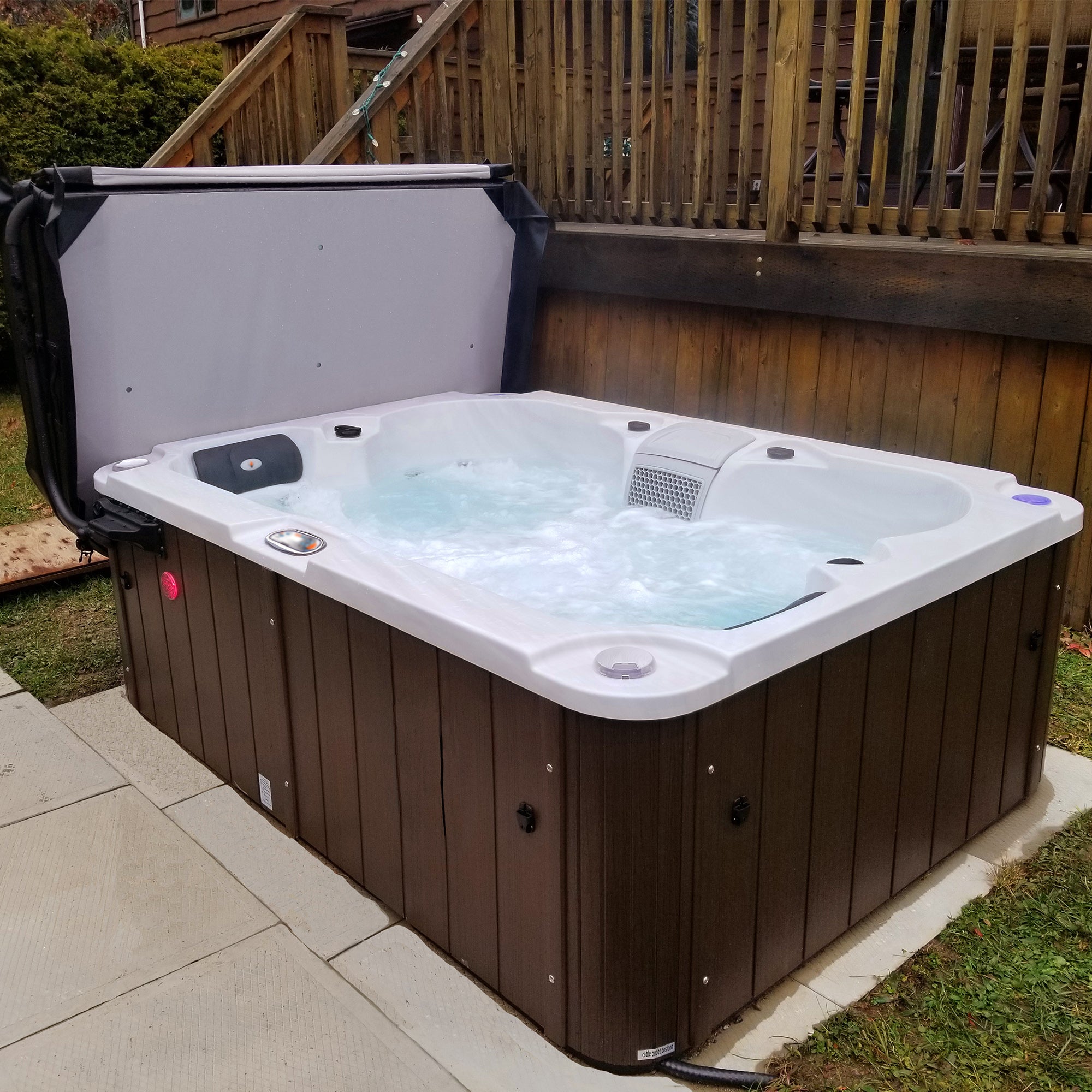 Hot tub with water features on a patio area