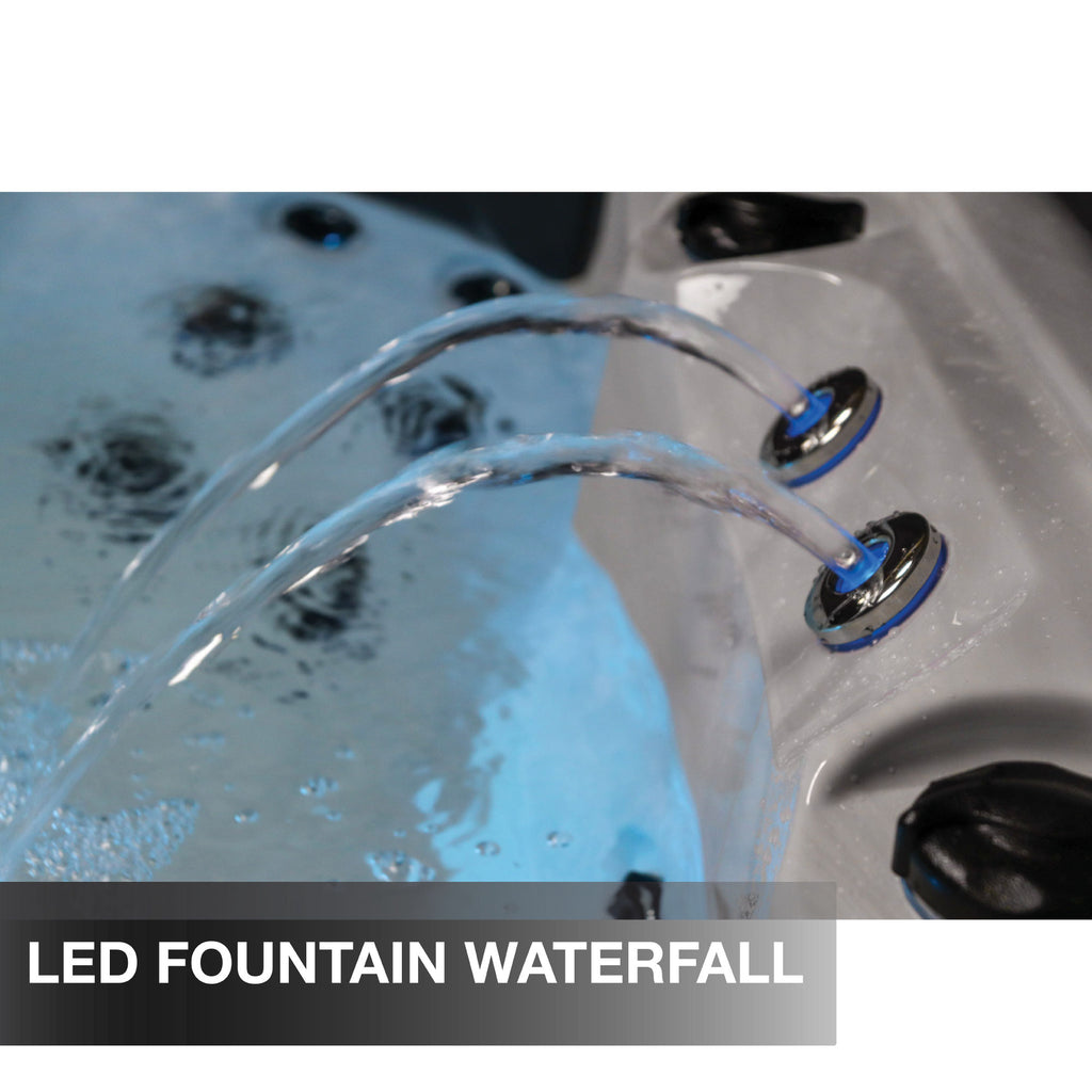 LED fountain waterfall feature in a hot tub with water flowing.
