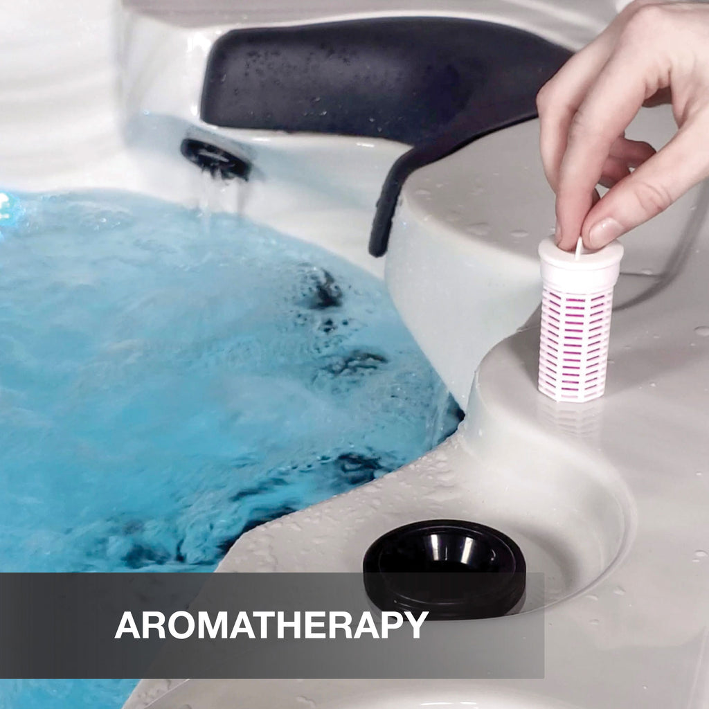 Hand placing a white and red filter into a hot tub with 'Aromatherapy' text overlay.