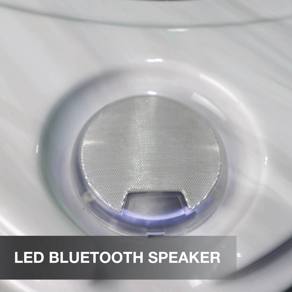Close-up of an LED Bluetooth speaker with a metallic finish.