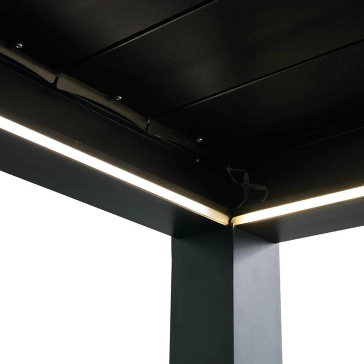 Modern linear LED under-cabinet lighting installed along the underside of a black metal ceiling and side frame, shown against a bright white background.