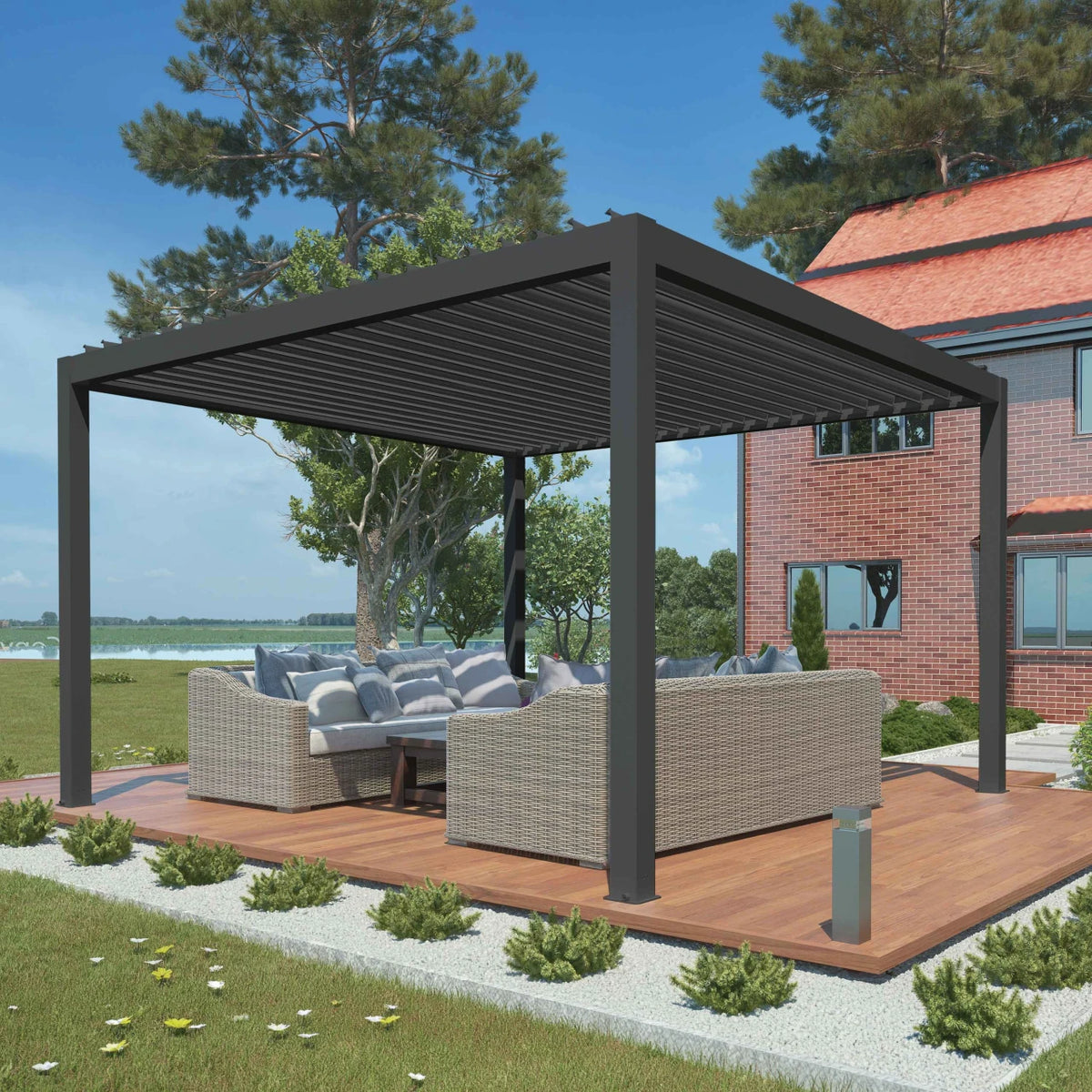 A modern outdoor patio pergola with a dark gray slatted roof and matching posts, supporting a wicker sofa and cushioned lounge set on a wooden deck in a landscaped backyard.