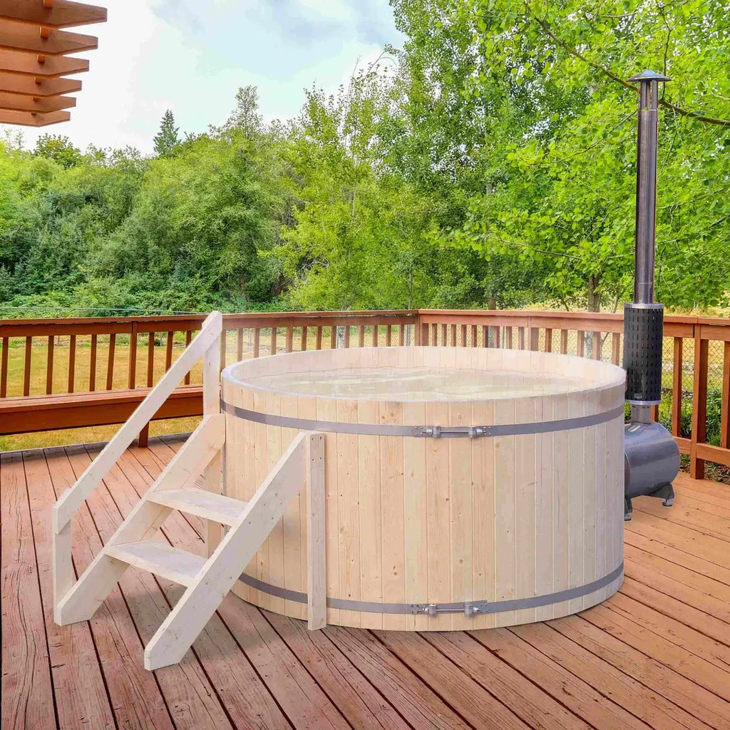 Wooden hot tub on a wooden deck with trees in the background