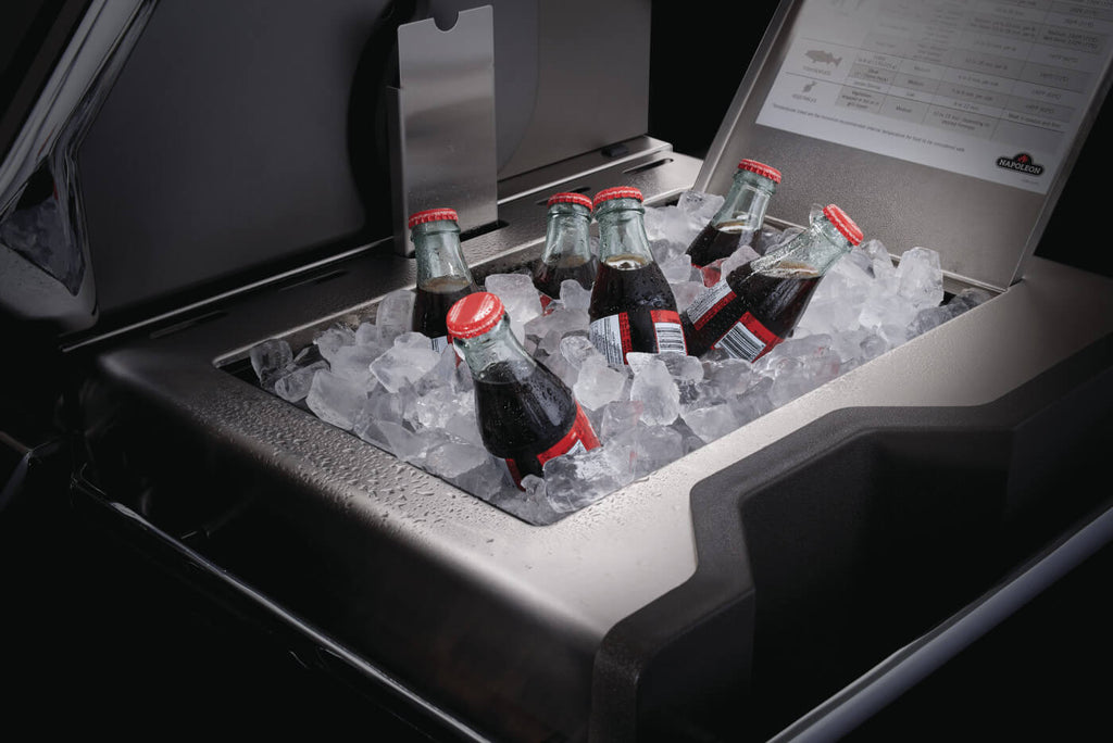 Bottles of Coca-Cola on ice in a cooler with a visible brand logo.