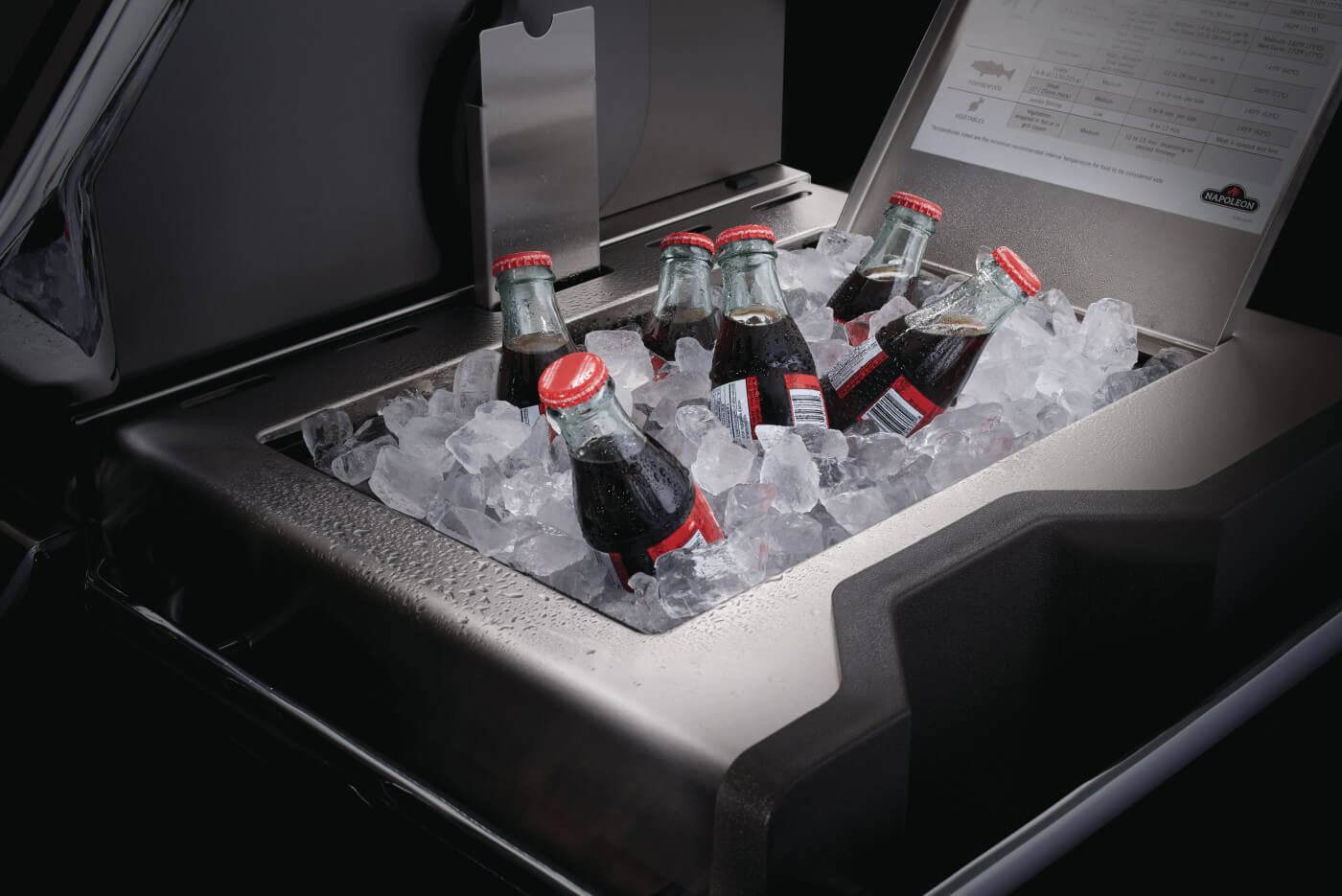 Bottles of Coca-Cola on ice in a cooler with a visible brand logo.