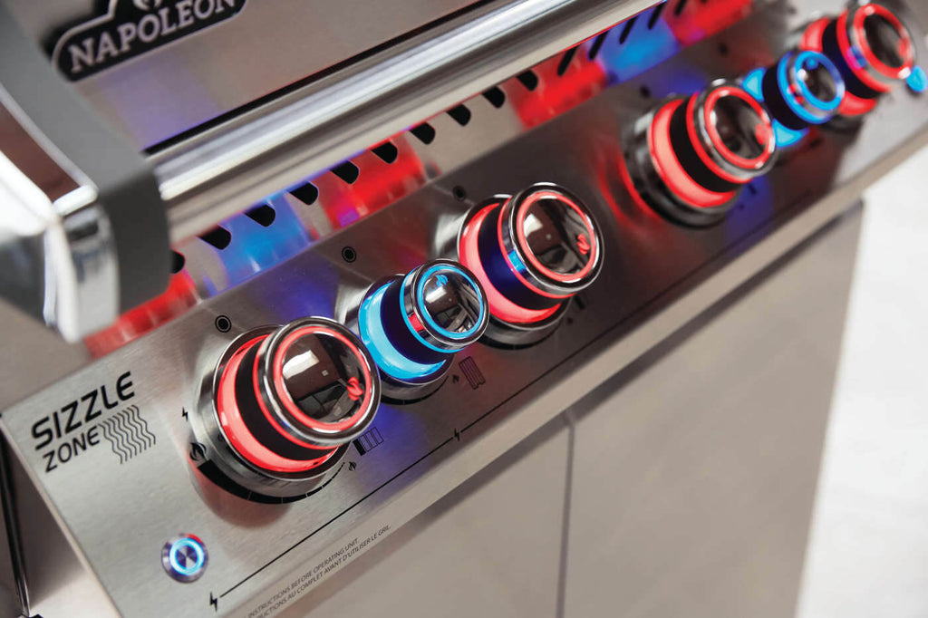 Close-up of a Napoleon grill with 'Sizzle Zone' control knobs.