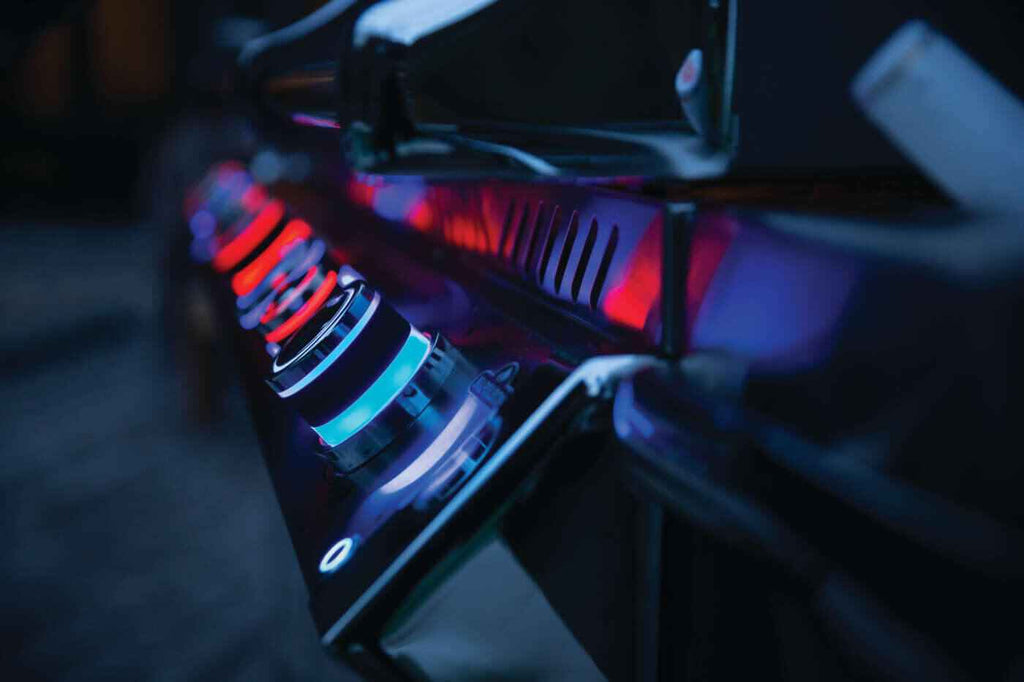 Close-up of a computer case with visible cooling system and RGB lighting in a dark setting