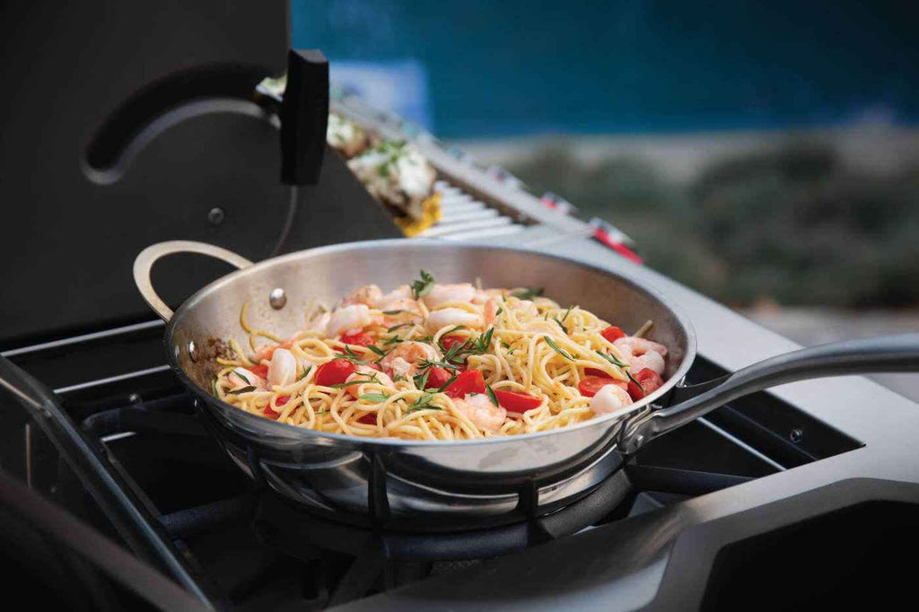 Pasta dish cooking on a portable stove outdoors