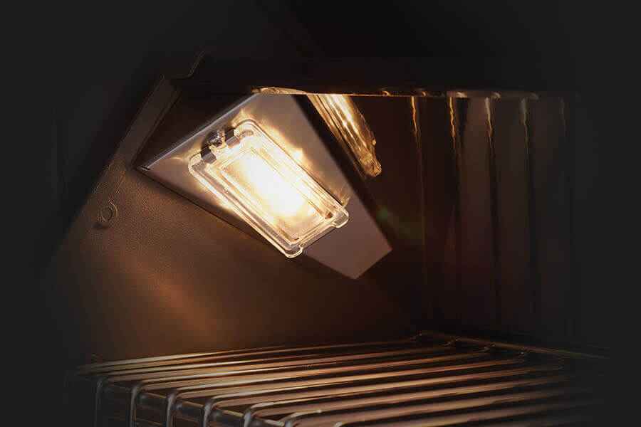 Light bulb inside an oven with a dark background
