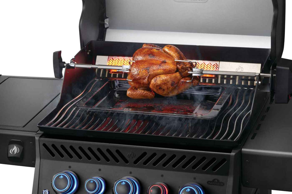 Roasted chicken on a rotisserie grill with a white background