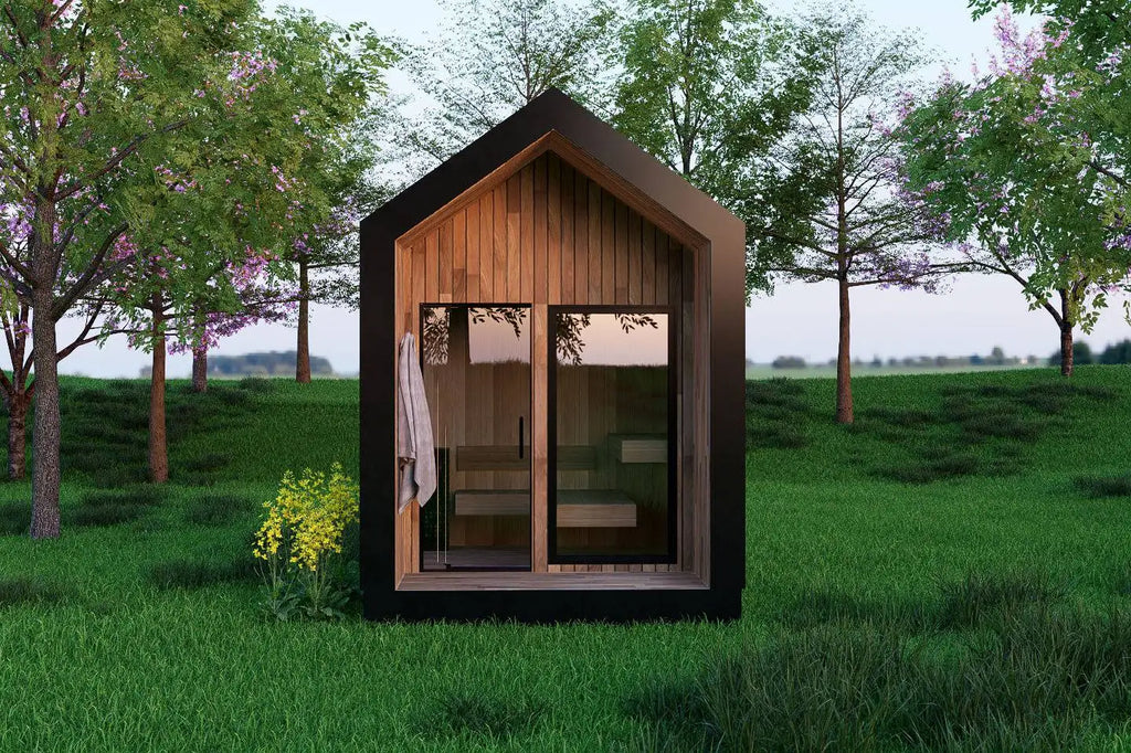 Modern sauna structure in a grassy field with trees in the background