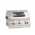 A stainless steel built-in gas grill with a curved lid, glass window, three control knobs with blue accents, and a temperature gauge on top, shown on a plain white background.