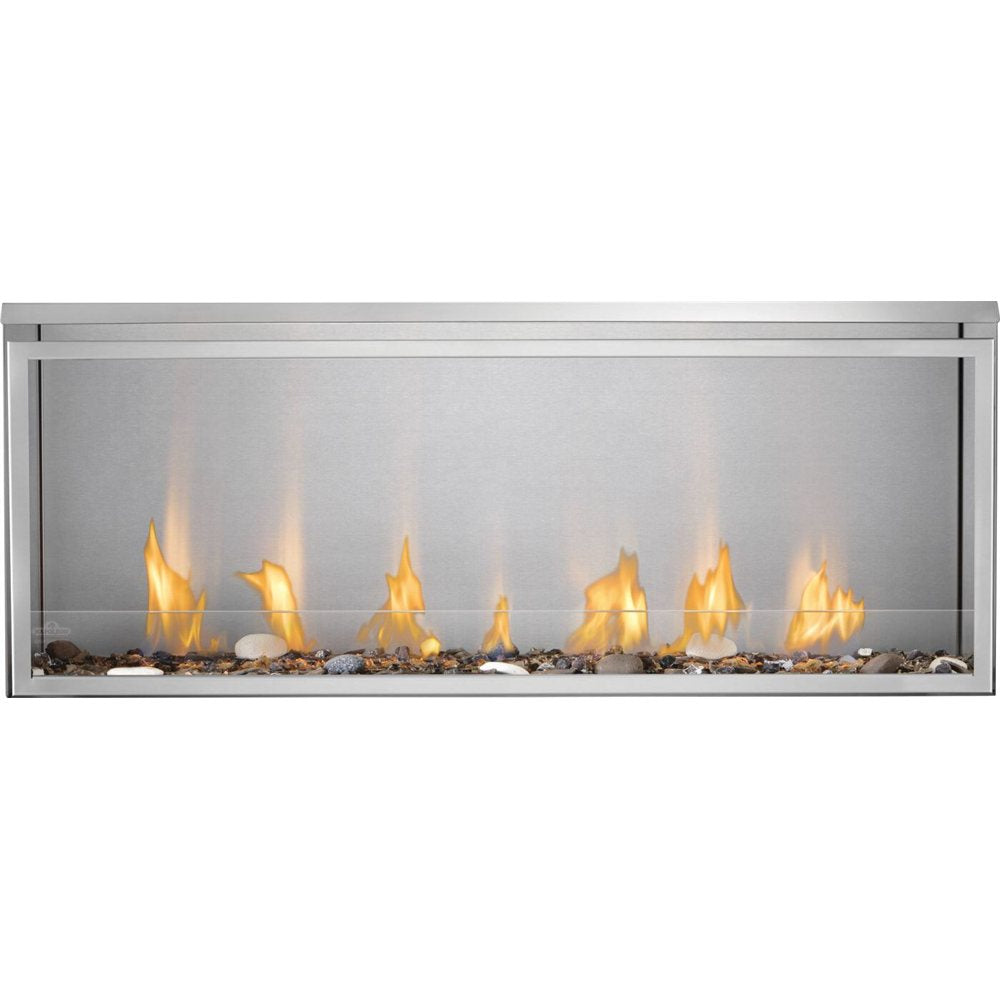 A modern linear fireplace with a stainless steel frame, featuring yellow and orange flames rising over decorative river rocks inside a clear glass front.