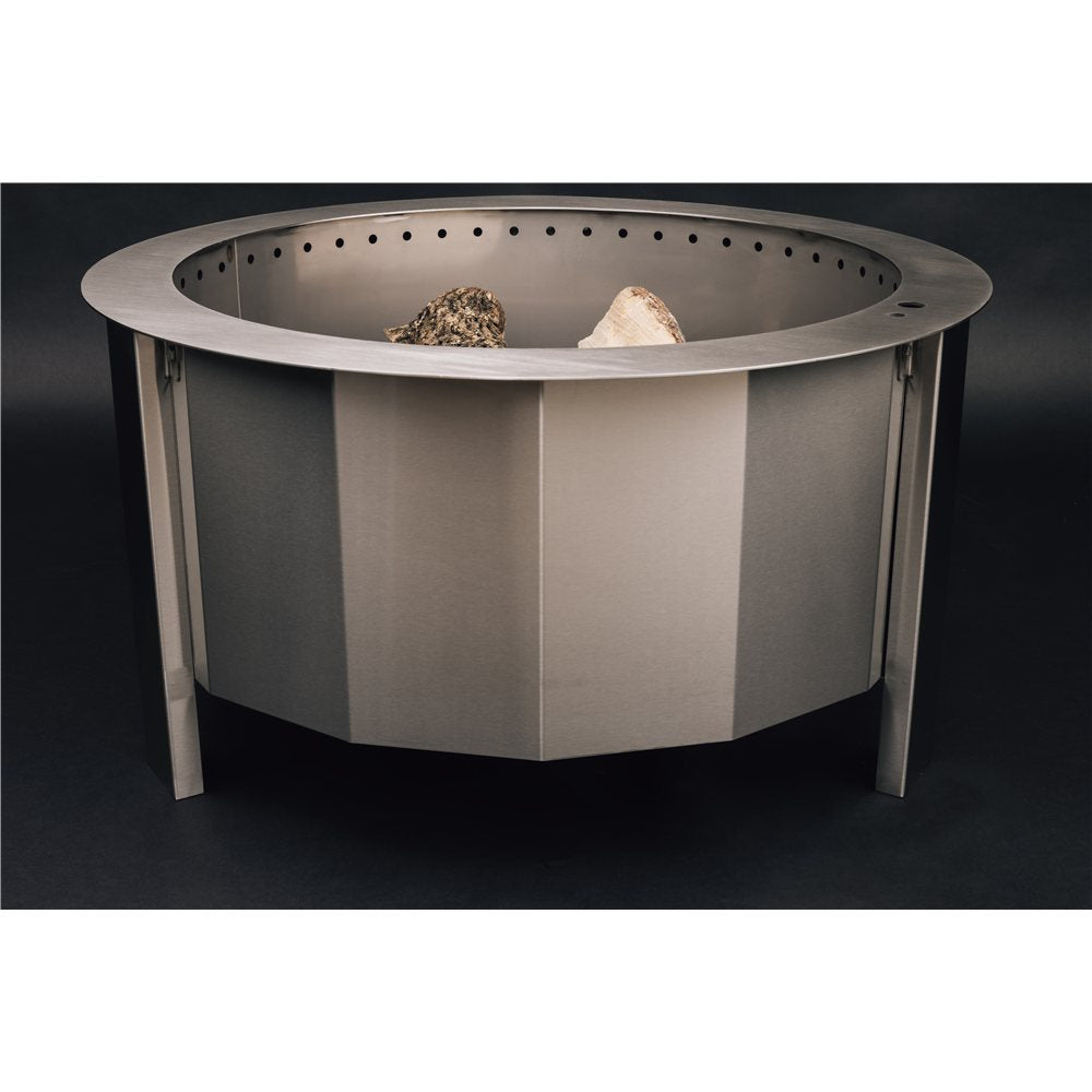 Metal fire pit with rocks on a black background
