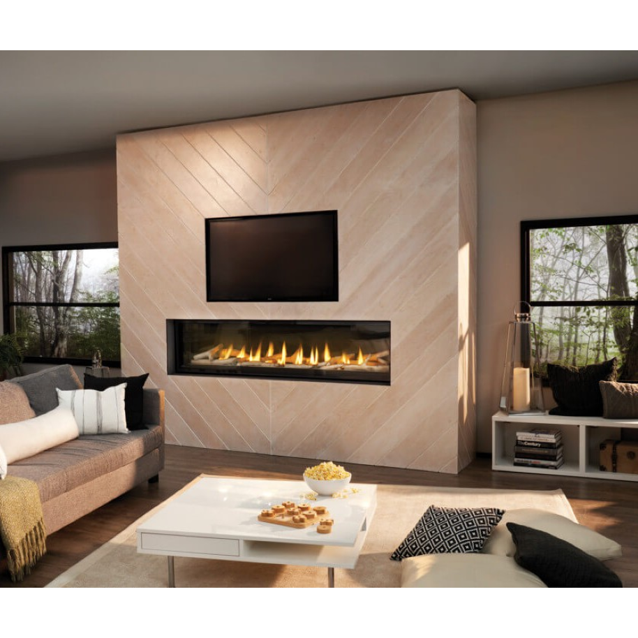 A modern linear gas fireplace with a black frame and visible flames, mounted on a light beige wood-paneled wall in a contemporary living room setting.