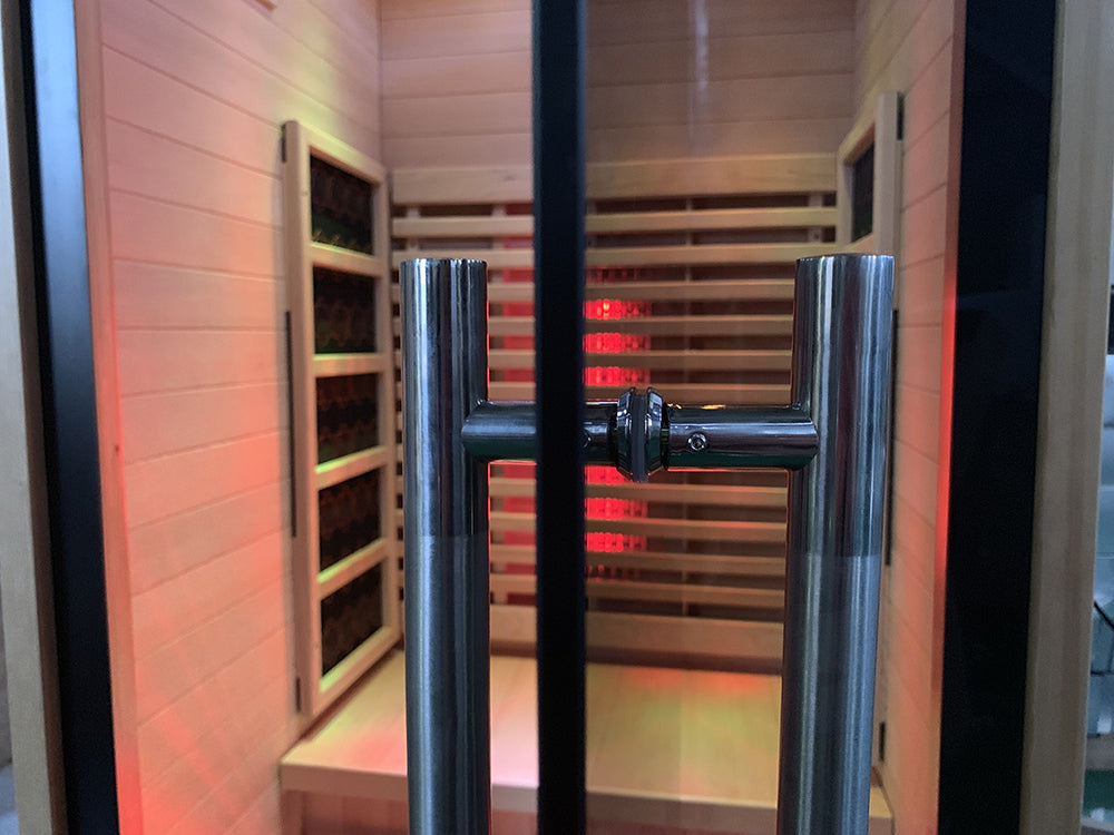 Infrared sauna with wooden benches and red lighting