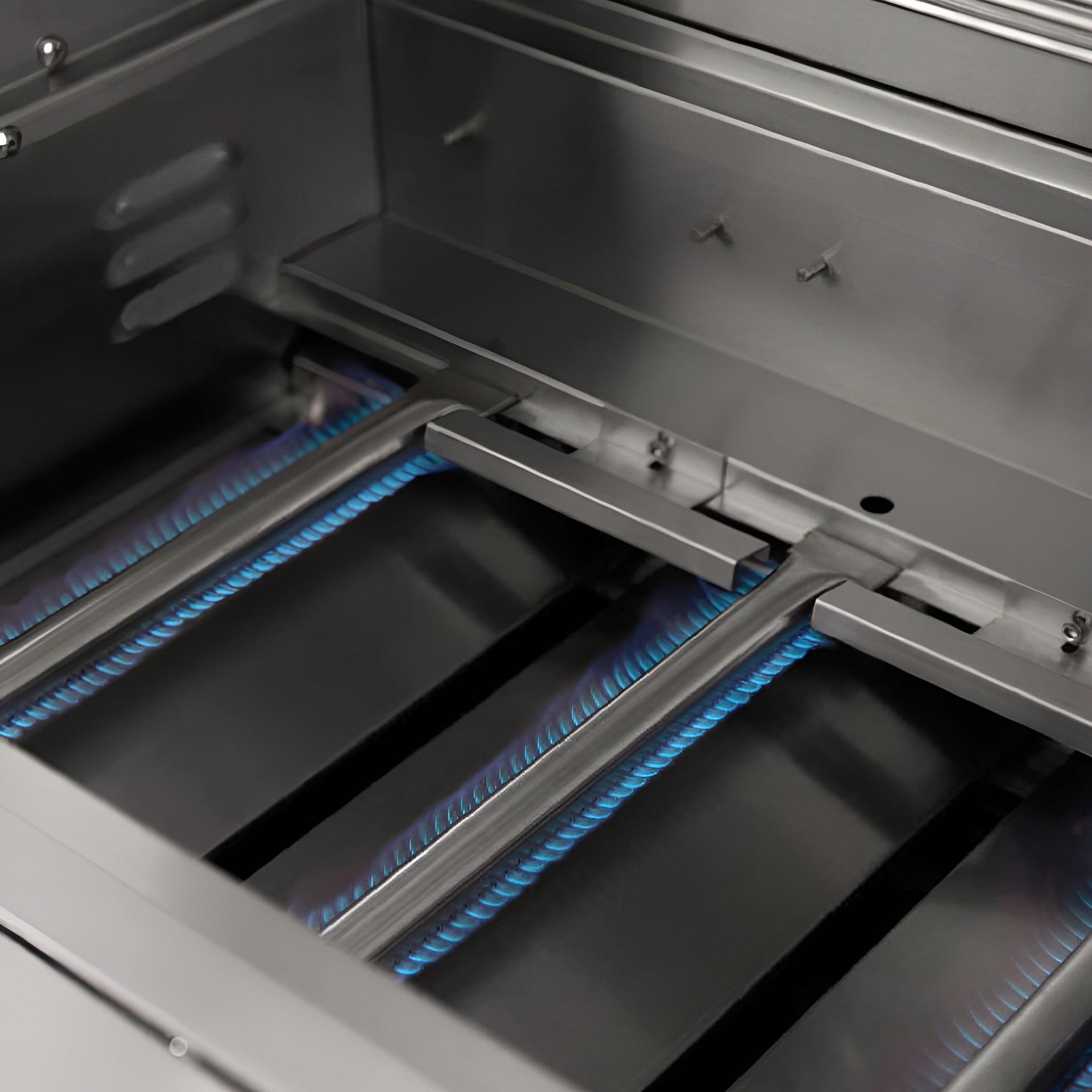 Close-up of a gas grill with visible flames inside the oven chamber.